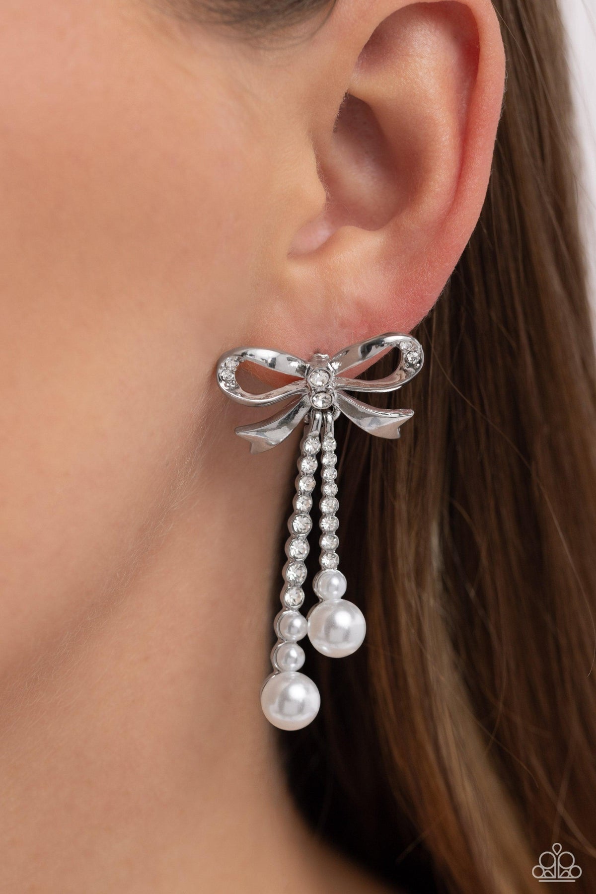 Bodacious Bow White Rhinestone &amp; Pearl Bow Earrings - Paparazzi Accessories-on model - CarasShop.com - $5 Jewelry by Cara Jewels