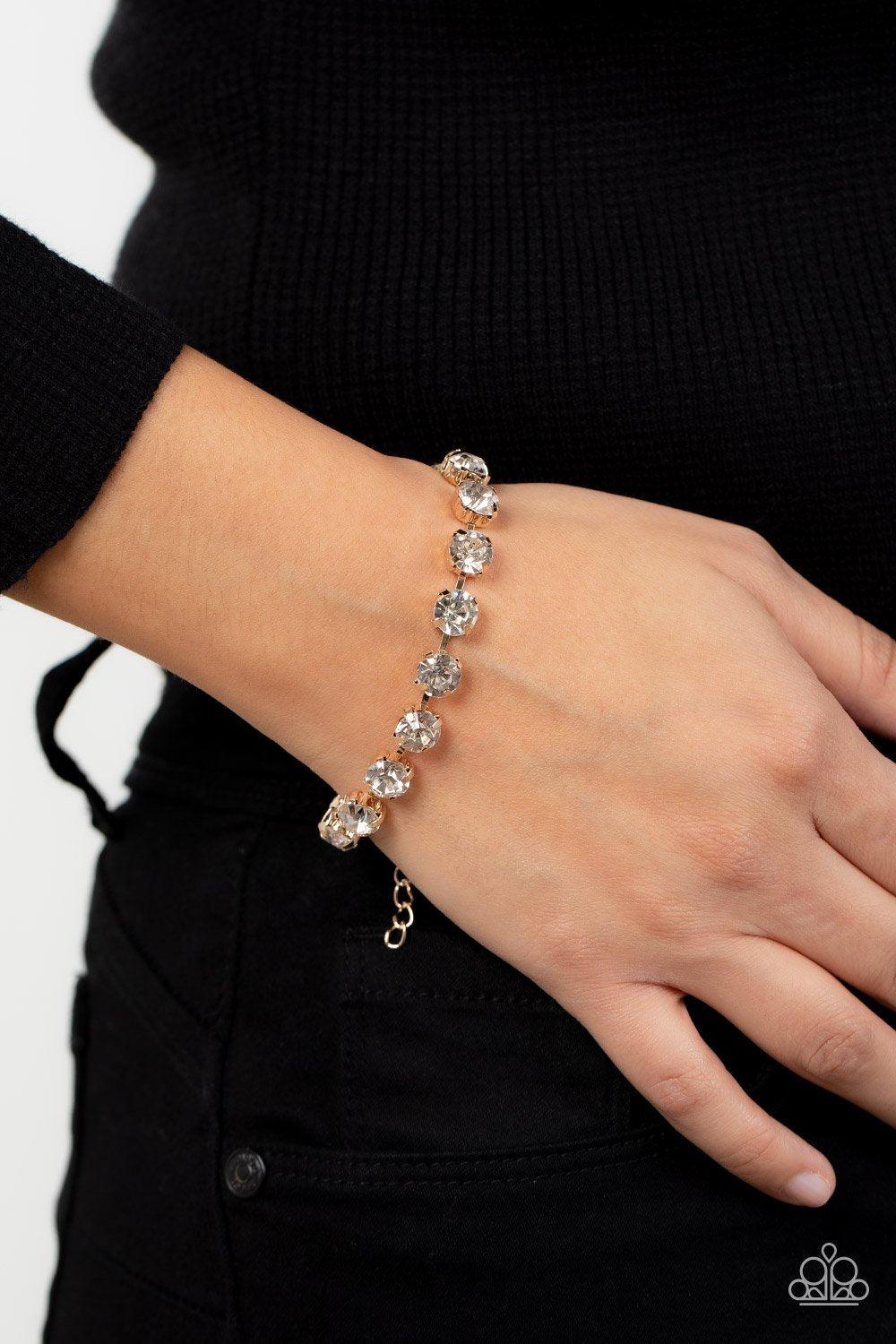 A-Lister Afterglow Gold and White Rhinestone Bracelet - Paparazzi Accessories- model - CarasShop.com - $5 Jewelry by Cara Jewels