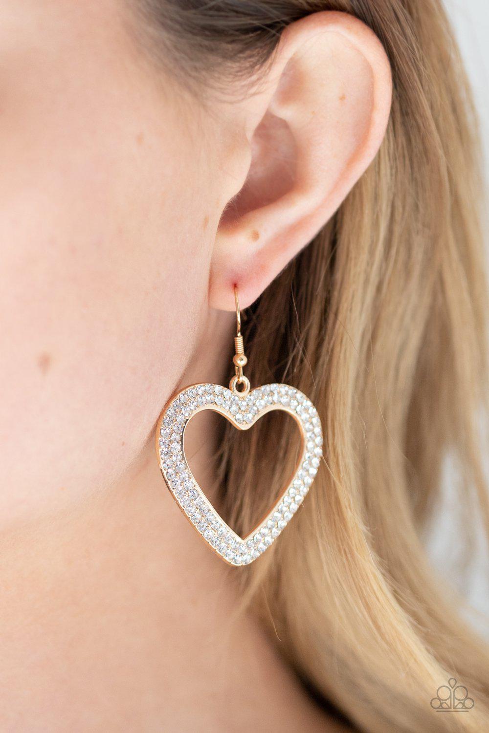 GLISTEN To Your Heart Gold and White Rhinestone Heart Earrings - Paparazzi Accessories - model -CarasShop.com - $5 Jewelry by Cara Jewels