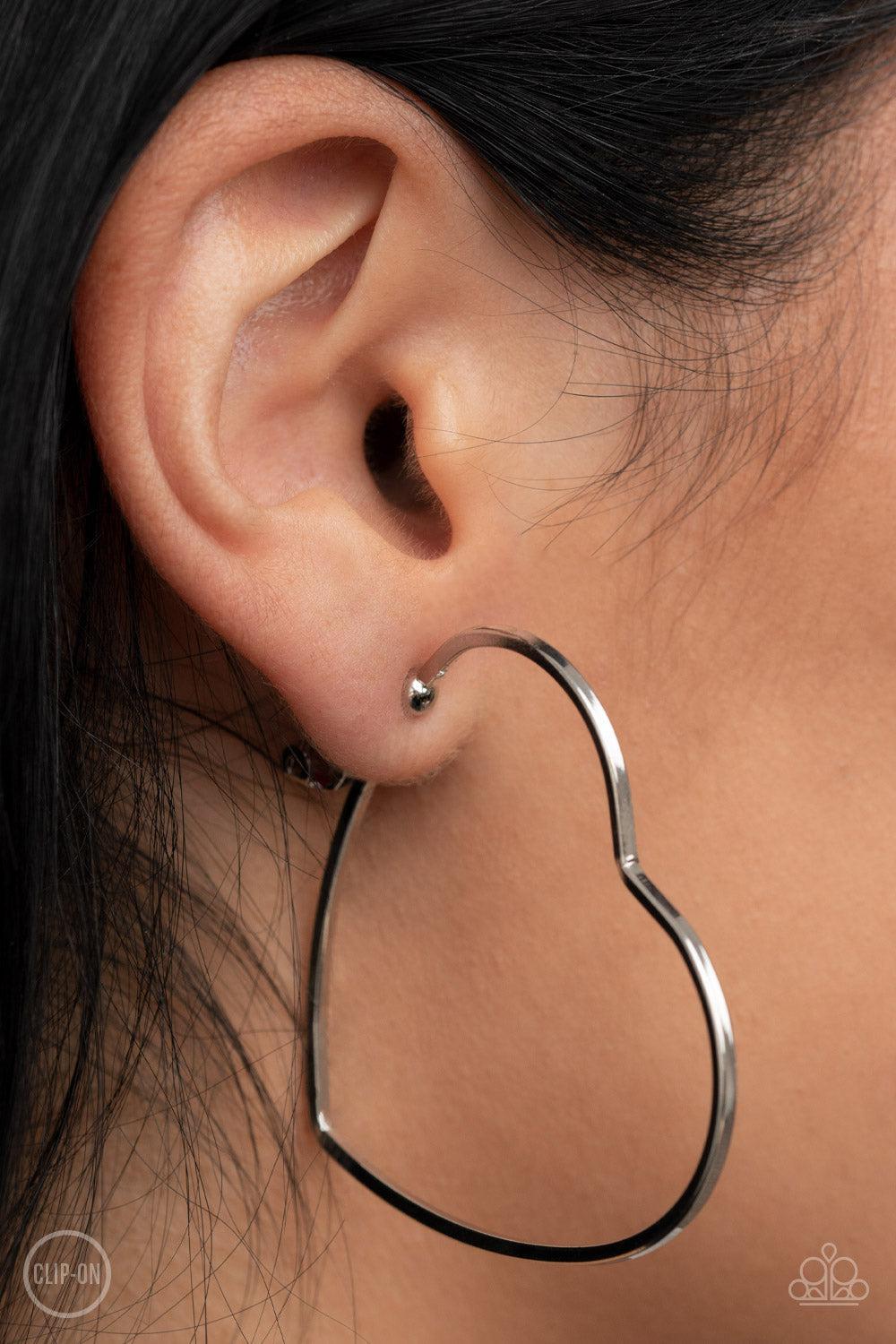 Harmonious Hearts Silver Clip-On Hoop Earrings - Paparazzi Accessories- on model - CarasShop.com - $5 Jewelry by Cara Jewels