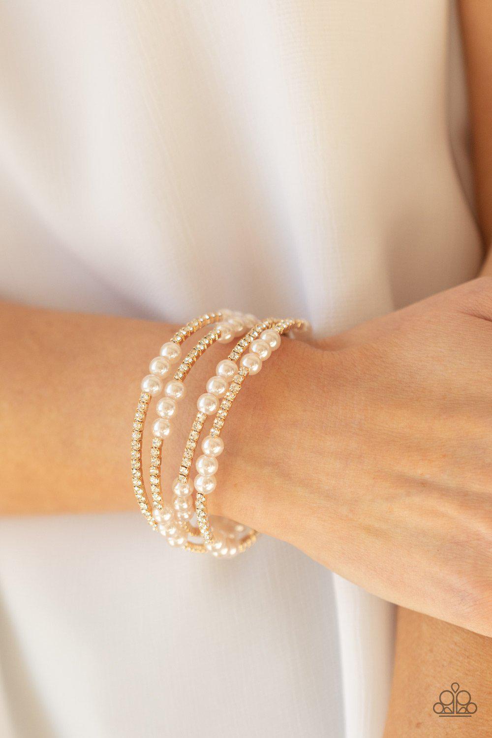 Hollywood Hospitality Gold, White Rhinestone and Pearl Infinity Wrap Bracelet - Paparazzi Accessories - model -CarasShop.com - $5 Jewelry by Cara Jewels